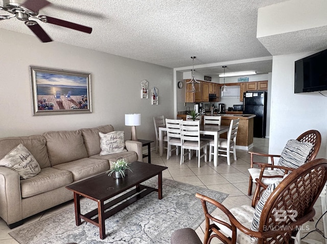 633 W Beach Blvd Unit 303, Gulf Shores, AL 36542 - living room with a ceiling fan, a textured ceiling, and light tile patterned floors