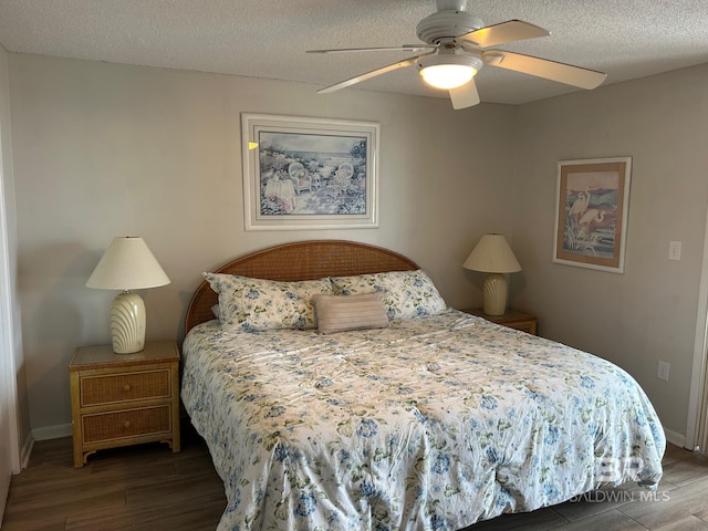 bedroom featuring ceiling fan, dark hardwood / wood-style flooring, and a textured ceiling