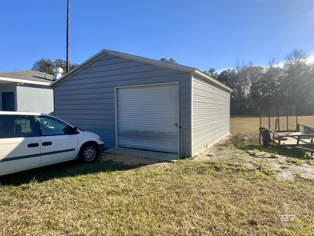 view of outbuilding featuring a garage and a yard