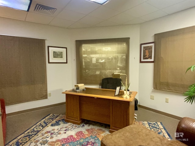 office space with a paneled ceiling and light colored carpet