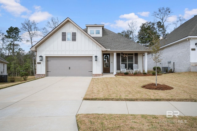 modern farmhouse featuring central AC, a shingled roof, concrete driveway, a front lawn, and board and batten siding