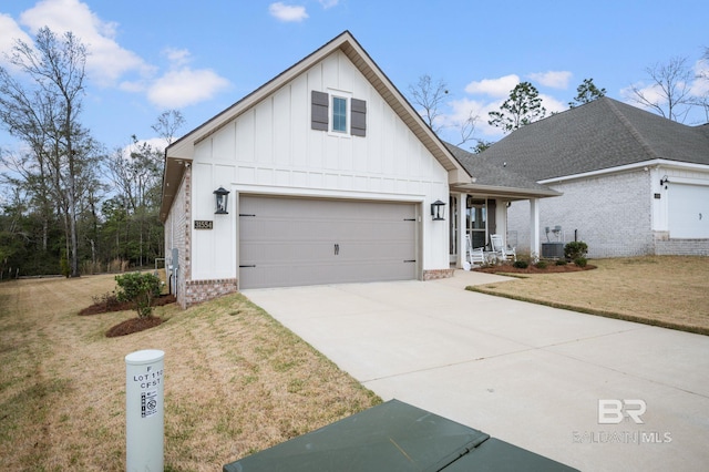 view of front of property featuring concrete driveway, covered porch, a front lawn, board and batten siding, and brick siding