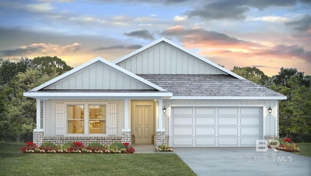 view of front of home with an attached garage, driveway, a lawn, and board and batten siding