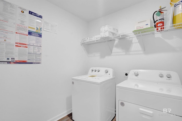 washroom featuring baseboards, laundry area, and washer and dryer