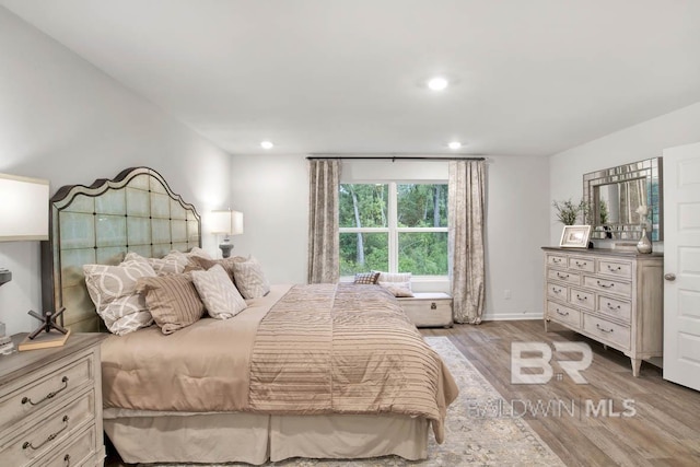 bedroom with recessed lighting, baseboards, and wood finished floors