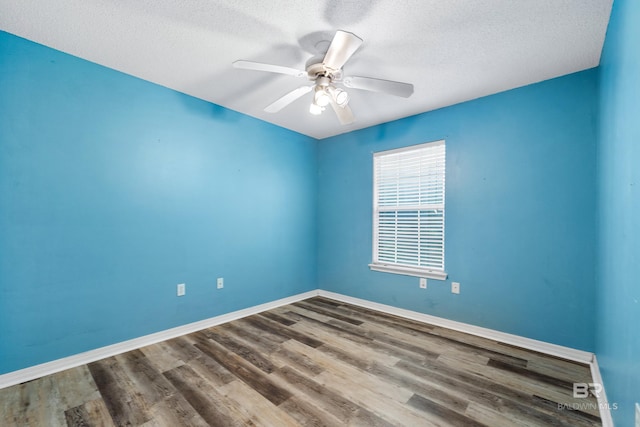 empty room with a textured ceiling, hardwood / wood-style flooring, and ceiling fan