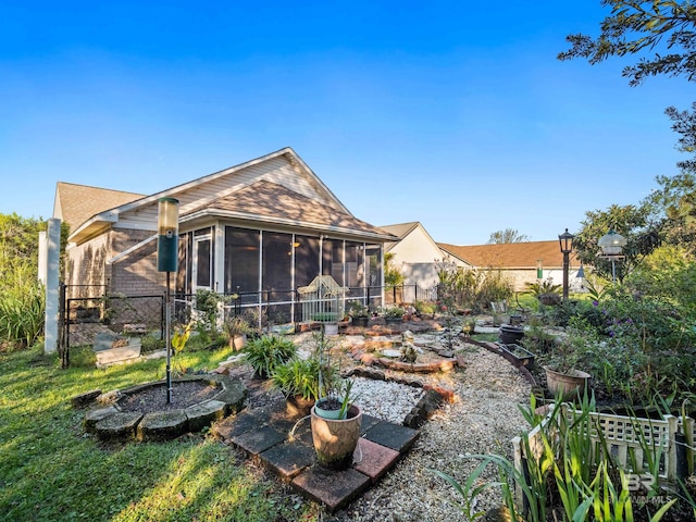 back of house featuring a sunroom