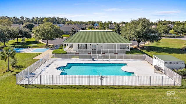 view of swimming pool with a patio area and a yard