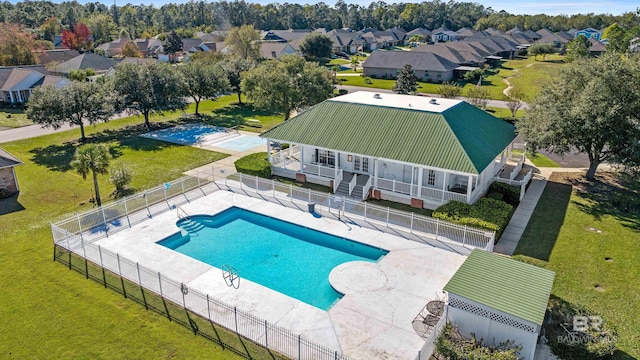 view of pool with a lawn and a patio area