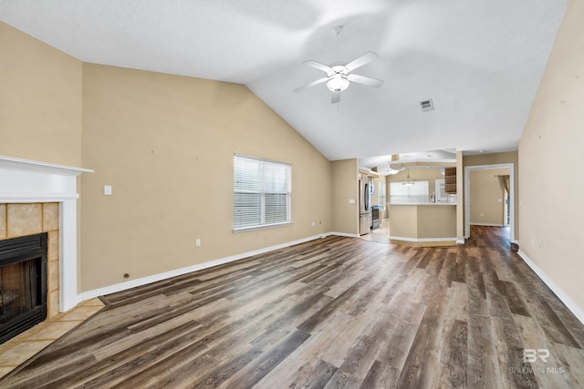 unfurnished living room featuring a fireplace, hardwood / wood-style flooring, ceiling fan, and lofted ceiling