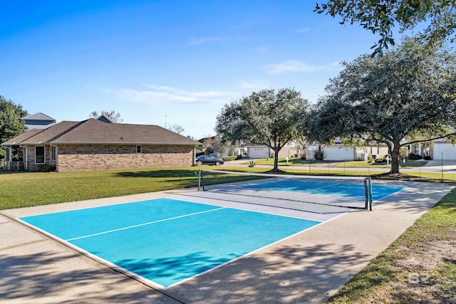 view of property's community featuring a lawn and tennis court