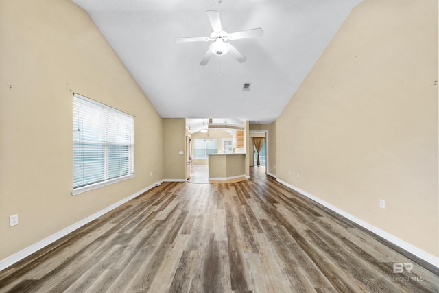 unfurnished living room with ceiling fan, vaulted ceiling, and hardwood / wood-style flooring