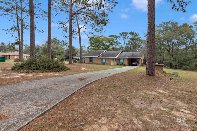 ranch-style home with driveway and brick siding