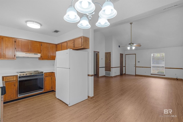 kitchen featuring under cabinet range hood, range with electric cooktop, visible vents, freestanding refrigerator, and brown cabinetry