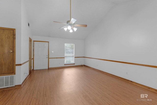 spare room featuring visible vents, high vaulted ceiling, light wood-type flooring, and a ceiling fan