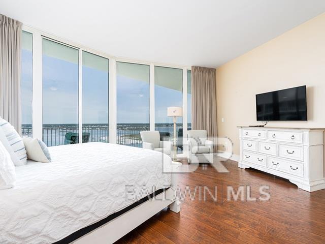 bedroom with dark hardwood / wood-style flooring and access to outside