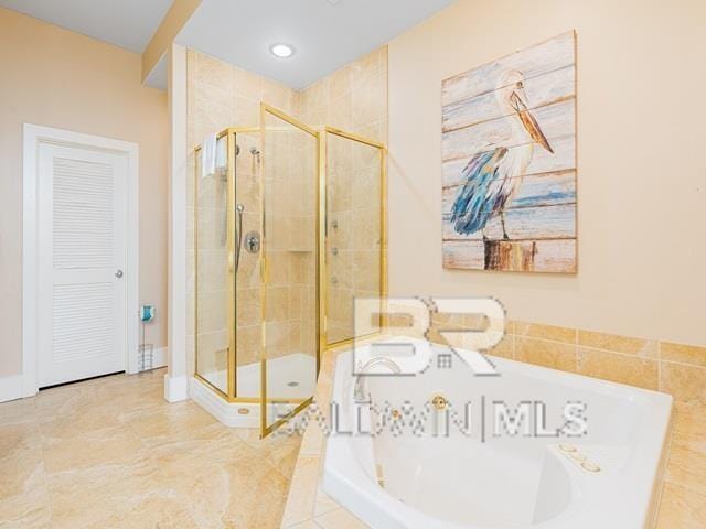 bathroom featuring tile patterned flooring and independent shower and bath