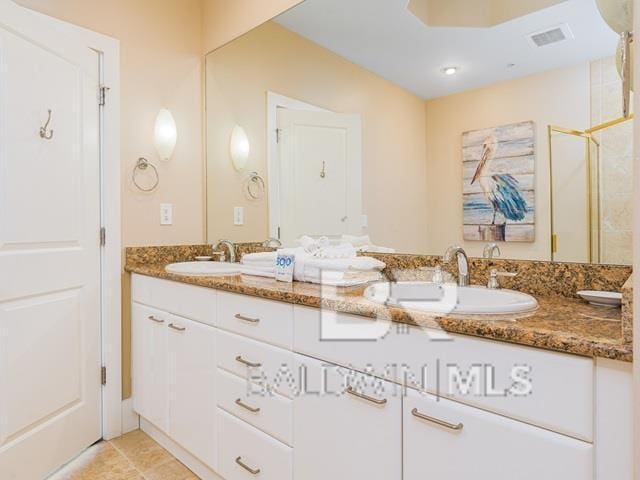 bathroom featuring tile patterned flooring and vanity