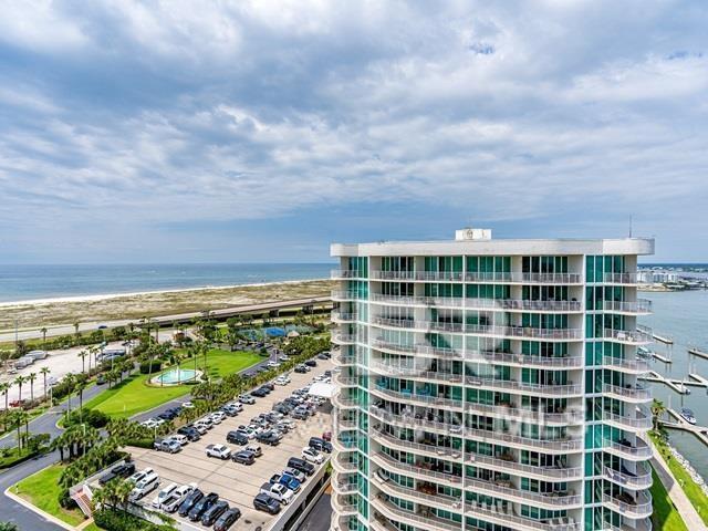 view of property with a water view and a view of the beach