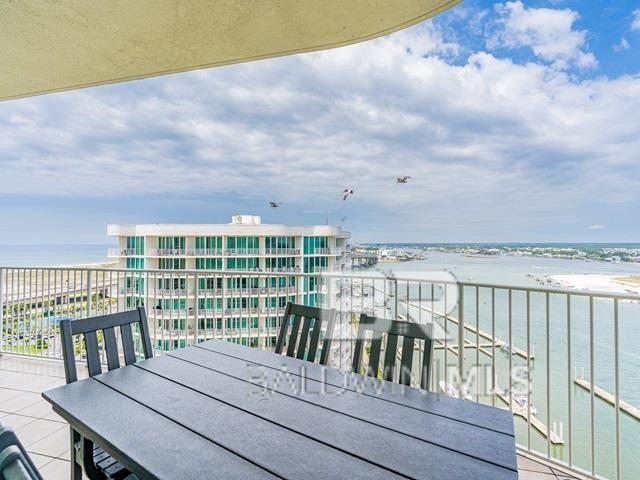 balcony with a beach view and a water view