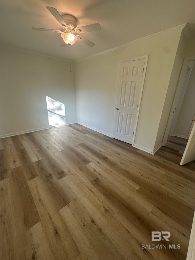 unfurnished room featuring crown molding, ceiling fan, and light hardwood / wood-style floors