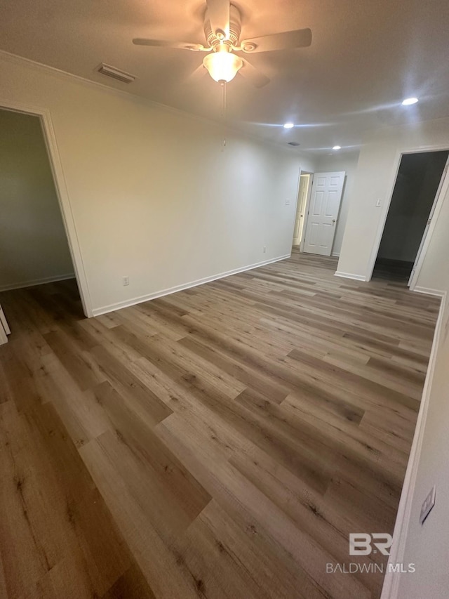 spare room featuring wood-type flooring and ceiling fan