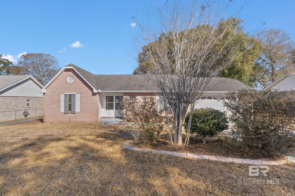 view of front of home featuring a garage and a front lawn