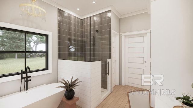 0 Olde Park Rd, Gulf Shores, AL 36542 - full bath featuring a soaking tub, tiled shower, a chandelier, wood finished floors, and ornamental molding