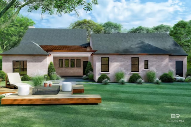 rear view of house featuring a lawn and stucco siding