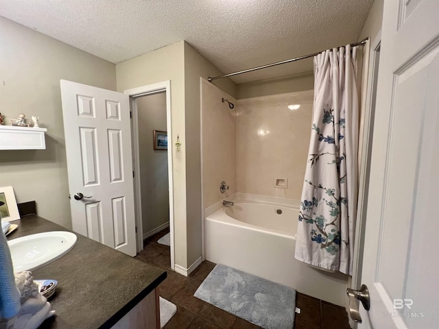 bathroom with tile patterned floors, vanity, a textured ceiling, and shower / bath combo with shower curtain