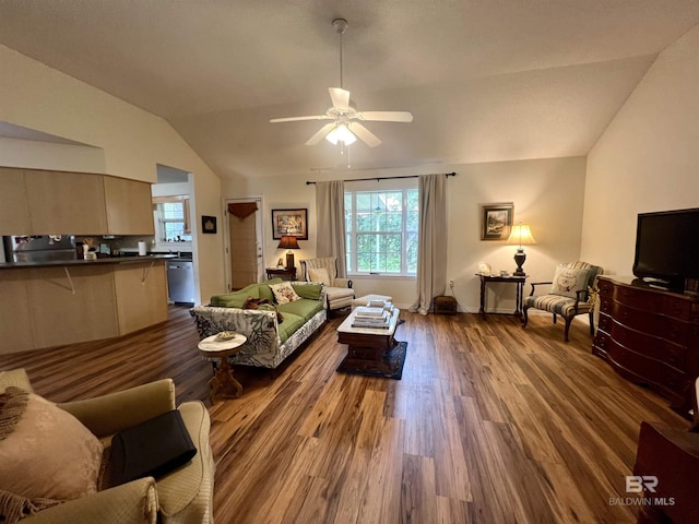 living room featuring ceiling fan, hardwood / wood-style floors, and vaulted ceiling