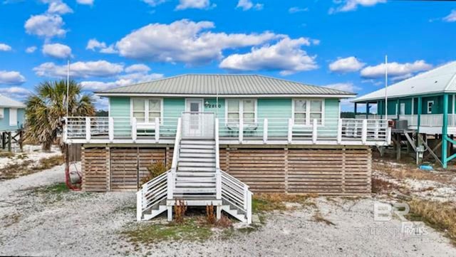 2800 W Beach Blvd, Gulf Shores, AL 36542 - view of front facade with stairs, metal roof, and a deck