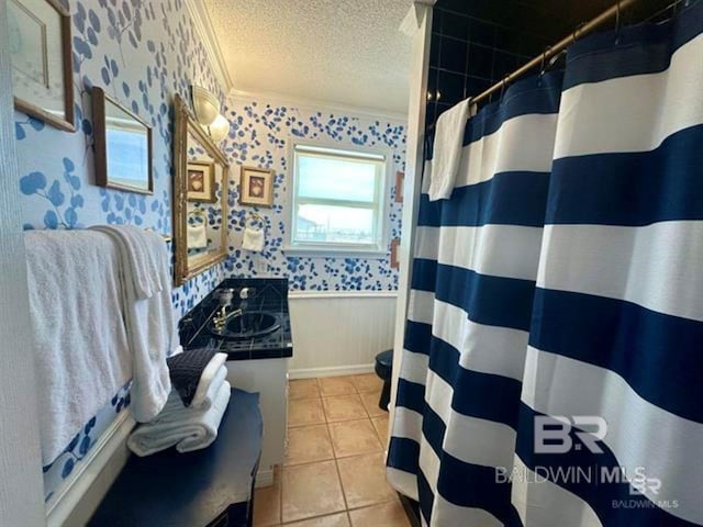 2800 W Beach Blvd, Gulf Shores, AL 36542 - full bathroom with wallpapered walls, tile patterned flooring, wainscoting, and a textured ceiling