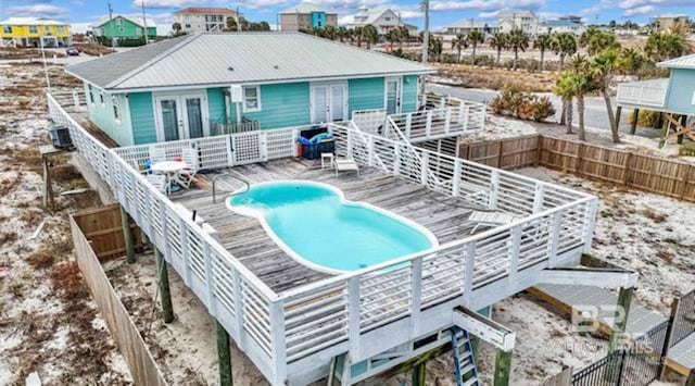 2800 W Beach Blvd, Gulf Shores, AL 36542 - view of swimming pool with french doors, a fenced in pool, fence, and a wooden deck