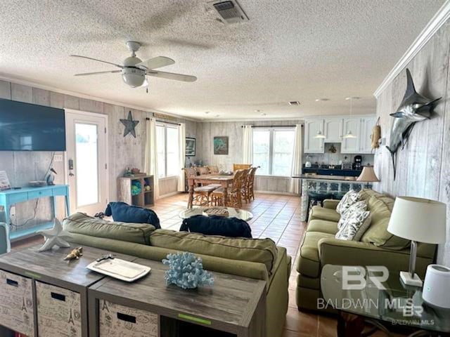 2800 W Beach Blvd, Gulf Shores, AL 36542 - living area featuring ornamental molding, visible vents, tile patterned flooring, and a ceiling fan