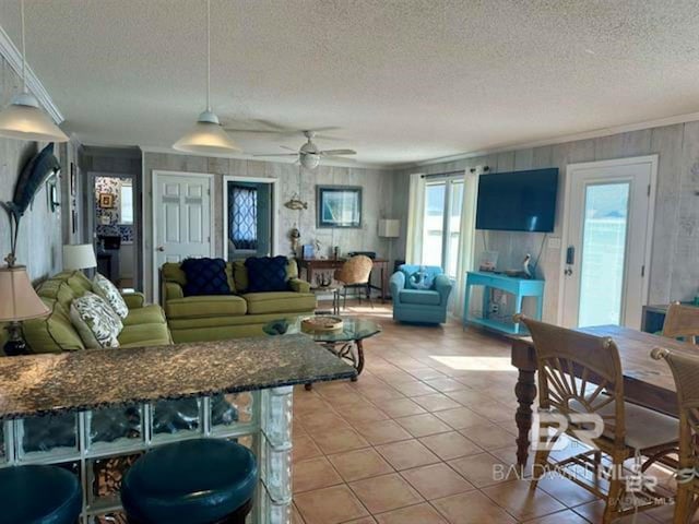 2800 W Beach Blvd, Gulf Shores, AL 36542 - living room with a textured ceiling, ornamental molding, ceiling fan, and light tile patterned floors