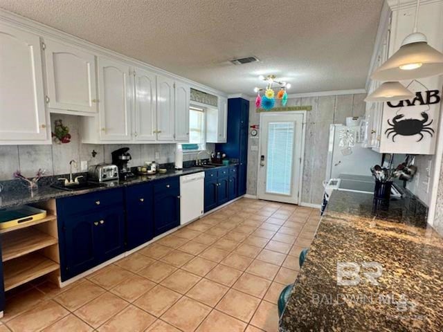 2800 W Beach Blvd, Gulf Shores, AL 36542 - kitchen featuring crown molding, white cabinetry, light tile patterned floors, white appliances, and blue cabinetry