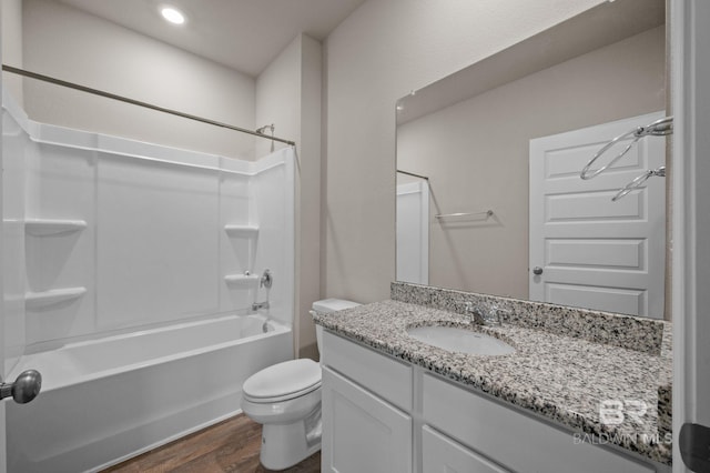 bathroom with wood finished floors, toilet, vanity, washtub / shower combination, and recessed lighting