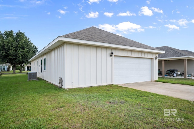 view of property exterior featuring board and batten siding, central AC, a yard, roof with shingles, and driveway