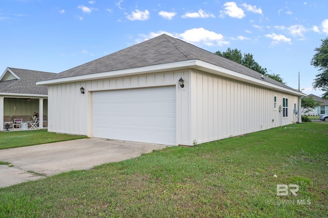 view of home's exterior with board and batten siding, a yard, and concrete driveway