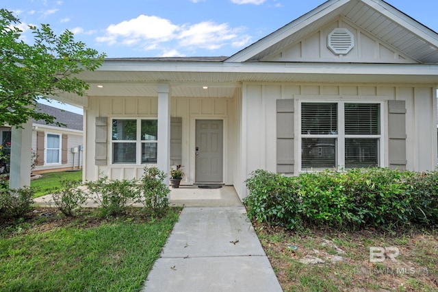 property entrance featuring board and batten siding