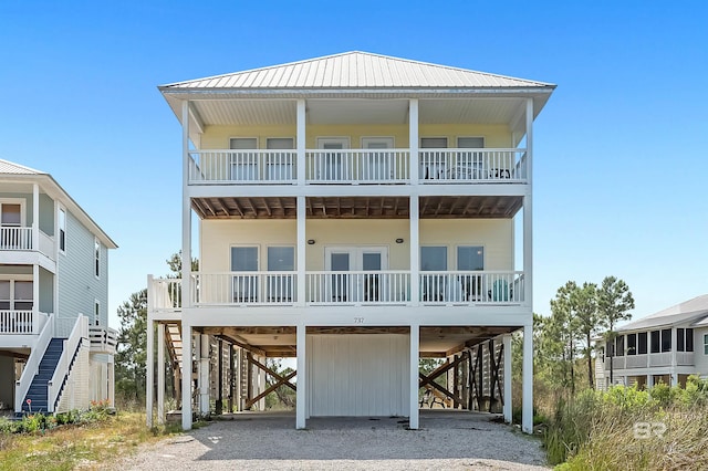 rear view of house with a carport and a balcony