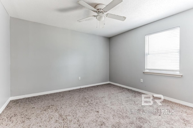 empty room featuring carpet flooring, ceiling fan, and baseboards