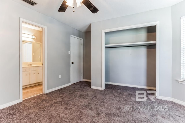 unfurnished bedroom featuring carpet floors, a closet, visible vents, connected bathroom, and baseboards