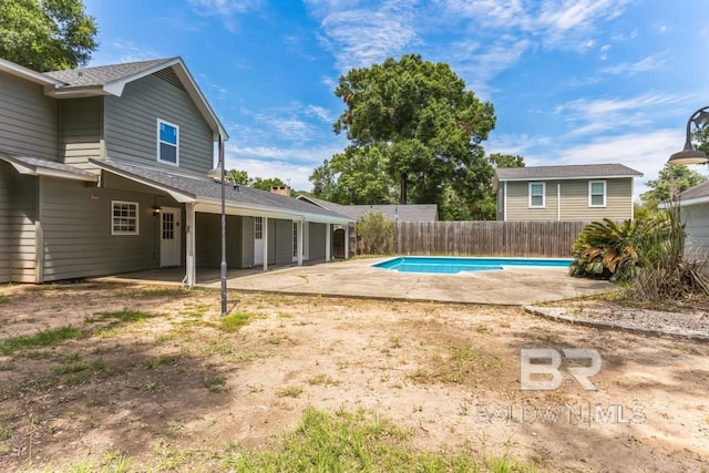 view of swimming pool with a patio, fence, and a fenced in pool