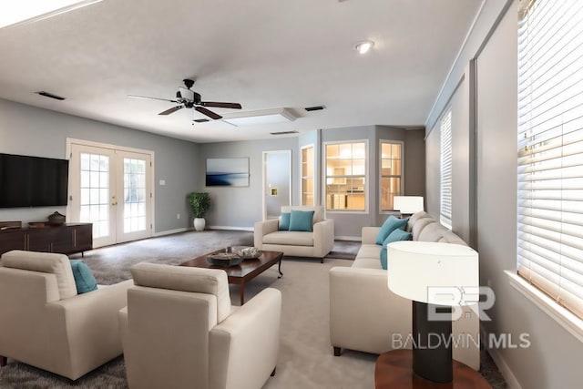 living area featuring french doors, carpet flooring, visible vents, and baseboards