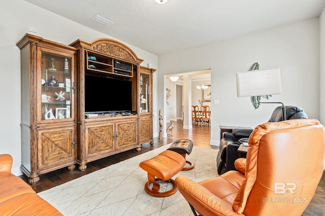 living room featuring an inviting chandelier and hardwood / wood-style flooring