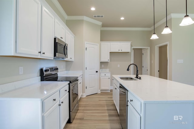 6902 Summerset Dr, Gulf Shores, AL 36542 - kitchen with a sink, stainless steel appliances, crown molding, white cabinets, and light wood-type flooring