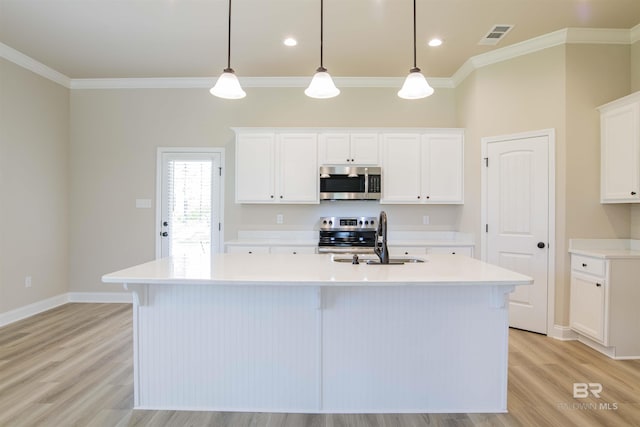 6902 Summerset Dr, Gulf Shores, AL 36542 - kitchen with appliances with stainless steel finishes, a sink, ornamental molding, light wood-style floors, and an island with sink