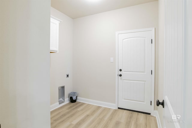 6902 Summerset Dr, Gulf Shores, AL 36542 - washroom featuring hookup for an electric dryer, light wood-style flooring, baseboards, and cabinet space